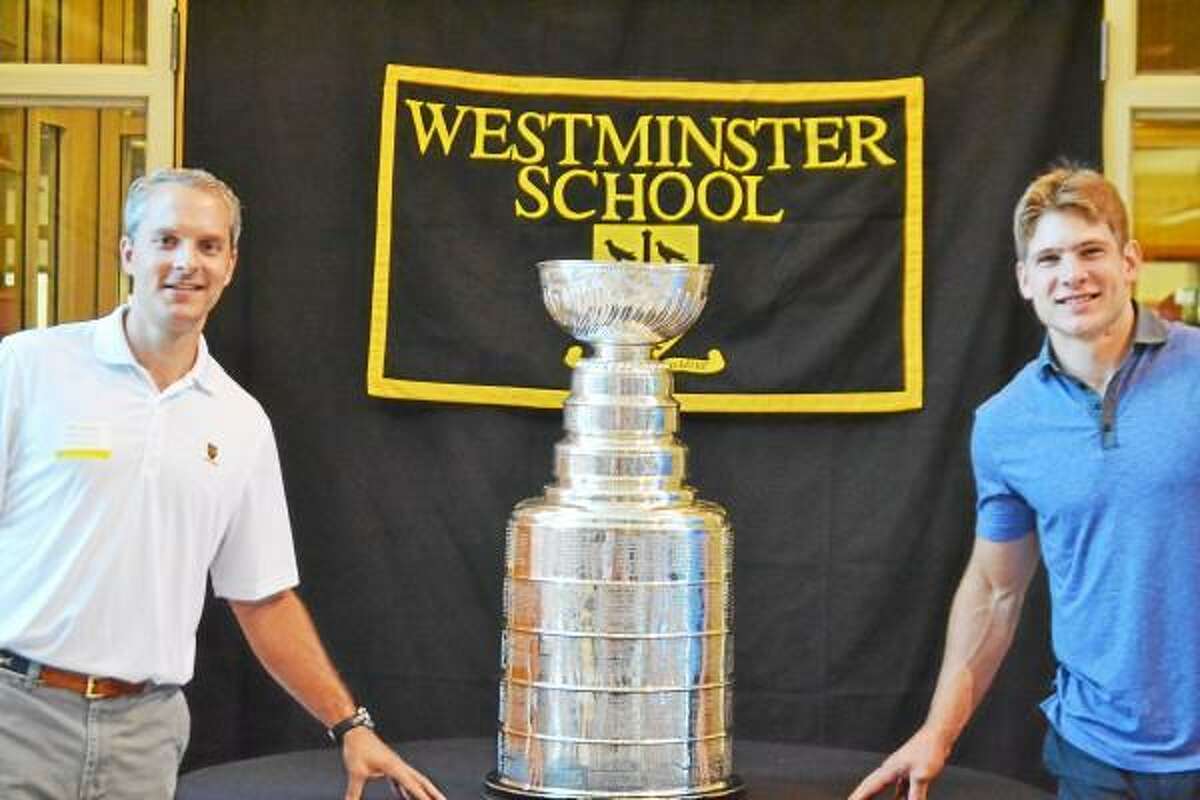 Pete Paguaga Register Citizen - Westminster athletic director, Tim Joncas and Westminster alum and current Chicago Blackhawks forward Ben Smith pose with the Stanley Cup.