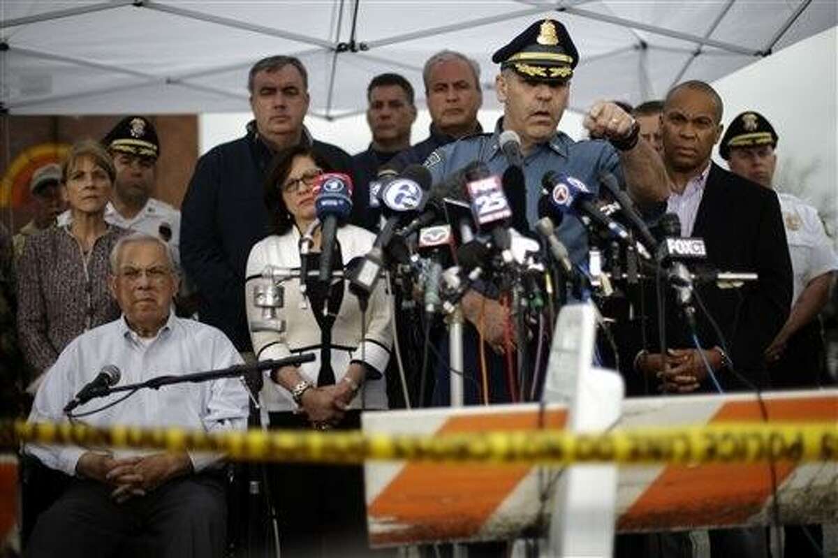 State Police Col. Timothy Alben, at podium, accompanied by Massachusetts Governor Deval Patrick, second right, and Boston Mayor Thomas Menino, lower left, gestures during a news conference regarding manhunt for Boston Marathon bombings suspect Dzhokar Tsarnaev, Friday, April 19, 2013, in Watertown, Mass. Alben said that he believed the19-year-old college student Tsarnaev was still in Massachusetts because of his ties to the area. But authorities lifted the stay-indoors warning for people in the Boston area, and the transit system started running again by evening. (AP Photo/Matt Rourke)