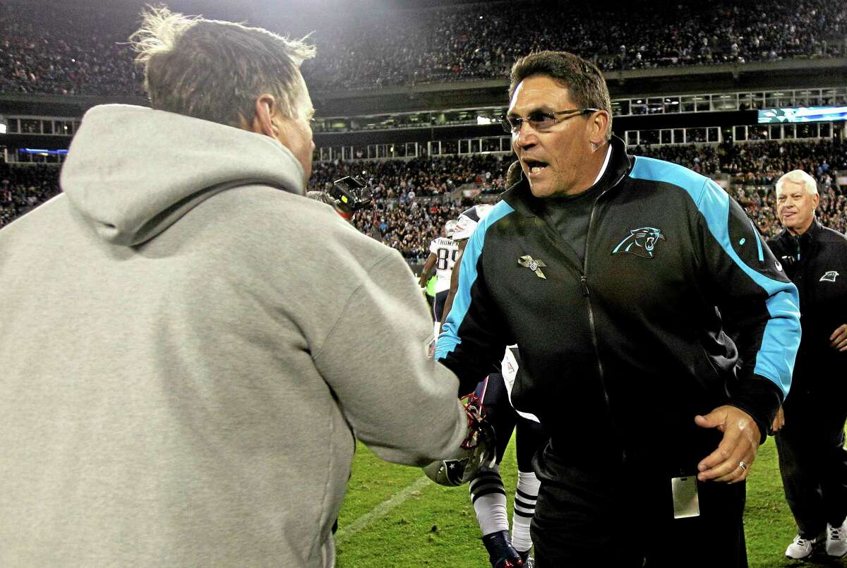 New England Patriots head coach Bill Belichick, left, and Carolina Panthers head coach Ron Rivera shake hands following Monday’s game in Charlotte, N.C.