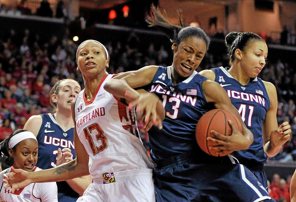 UConn’s Brianna Banks, right, and Maryland’s Alicia DeVaughn, left, reach for the ball.