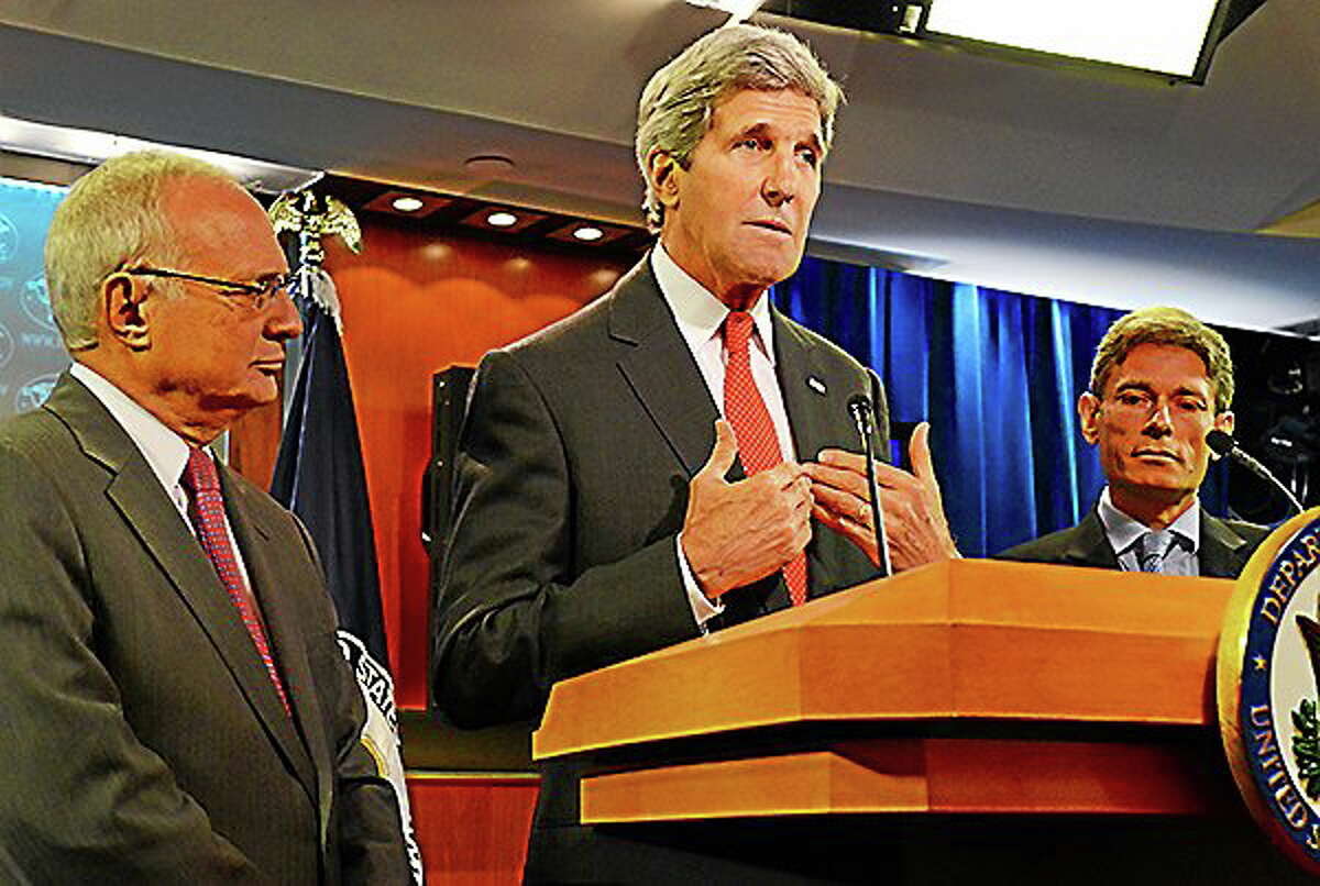 Secretary of State John Kerry released the 2013 annual report on international religious freedom at the U.S. Department of State in Washington, D.C., on July 28, 2014. Flanking Kerry is David Saperstein, left, President Obamaís nominee to serve as ambassador-at-large for international religious freedom, and Tom Malinowski, assistant secretary of state for democracy, human rights and labor.