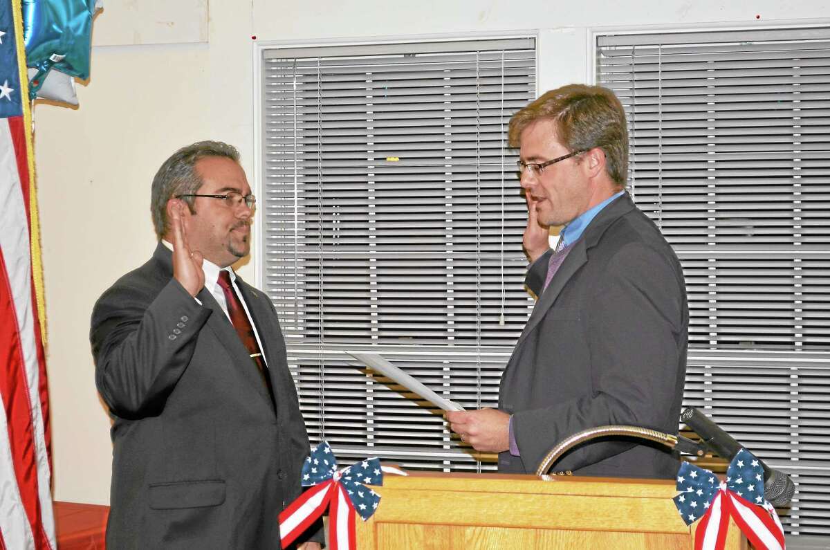 State Sen. Jason Welch, R-Bristol, left, swears in First Selectman Michael Criss at a Town Hall ceremony Monday night.