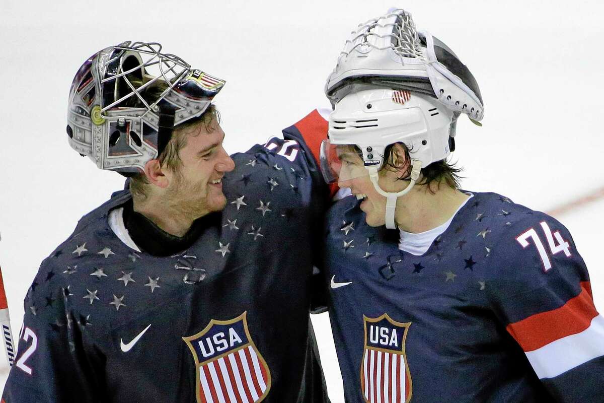 Team USA goaltender Jonathan Quick of Hamden greets forward T.J. Oshie, right, after Oshie scored the winning goal against Russia in the eighth round of a shootout after the two teams played to a 2-2 tie on Saturday at the Winter Olympics in Sochi, Russia.
