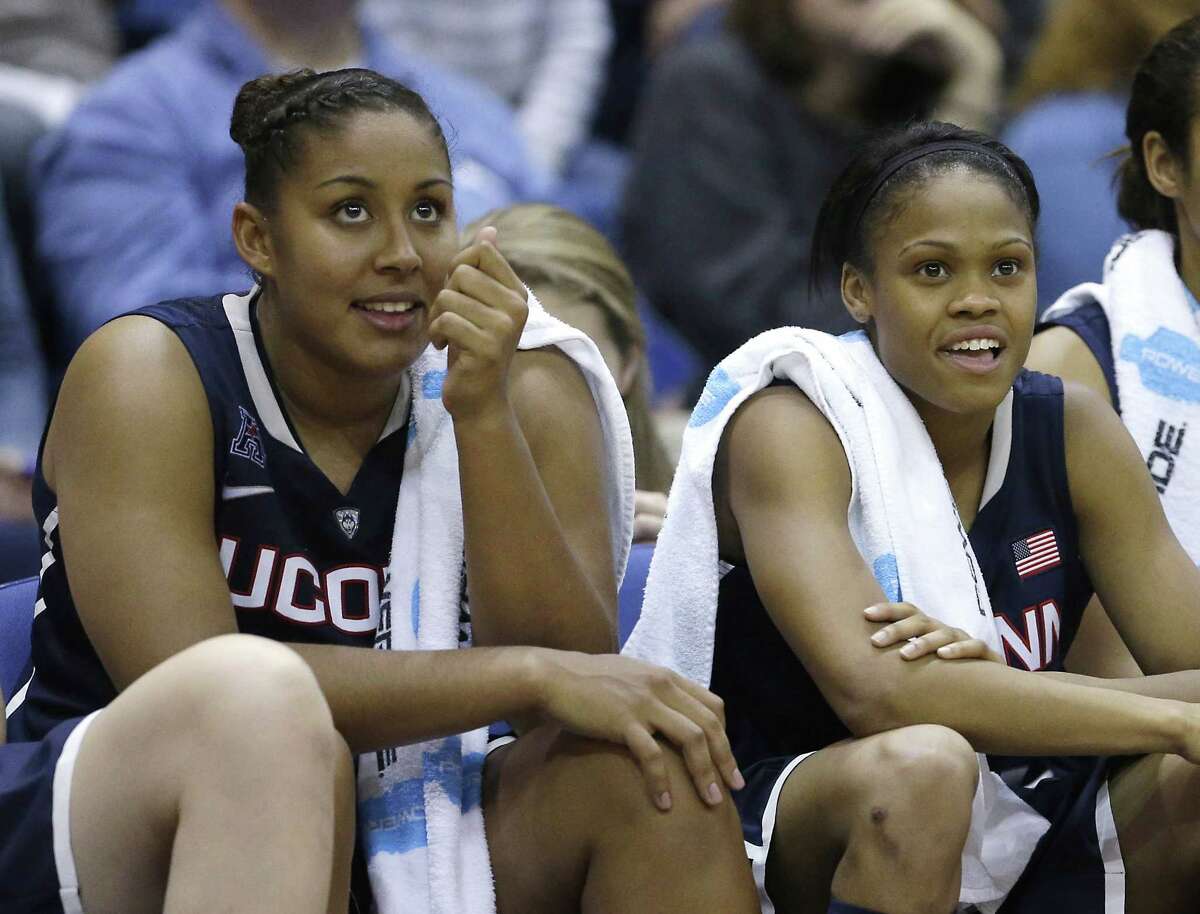 UConn’s Kaleena Mosqueda-Lewis, left, and Moriah Jefferson watch the closing moments of the No. 1 Huskies’ 102-43 win over UC Davis on Friday night in their season opener in Davis, Calif.