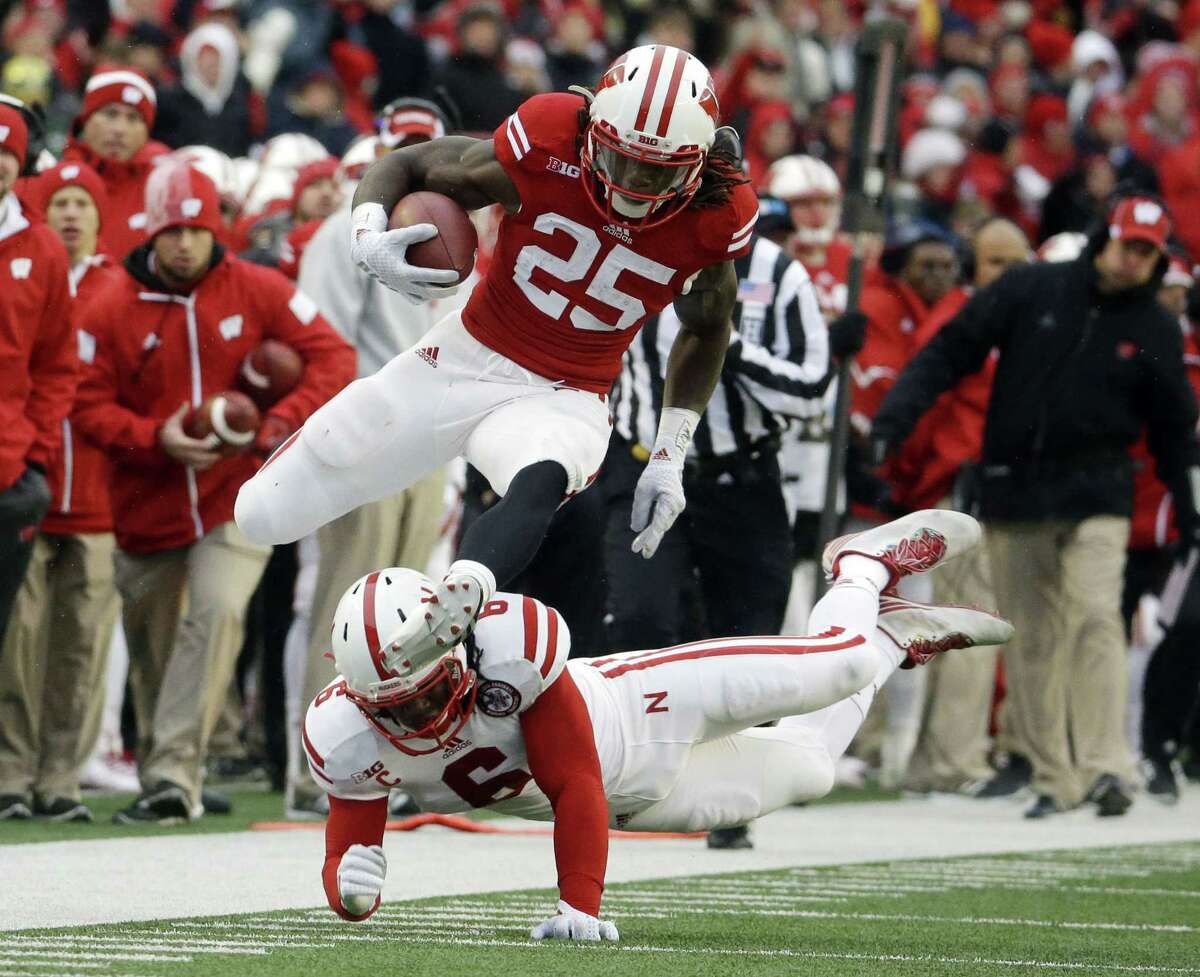 Wisconsin’s Melvin Gordon (25) breaks away from Nebraska’s Corey Cooper for a 62-yard touchdown run during the first half of Saturday’s game in Madison, Wis.