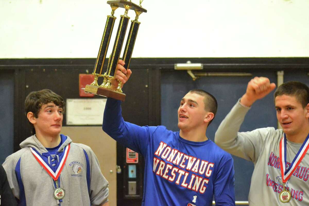 Nonnewaug’s John D’Agostino lifts the Berkshire League Championships trophy. The Chiefs won the Berkshire League league title with the score of 167 points.