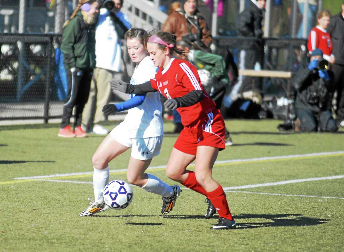 Jimmy Zanor - Middletown Press Housatonic's Chloe Dakers and Portland's Madison Leary fight to control the ball in the Class S finals at Waterbury's Municipal Stadium.