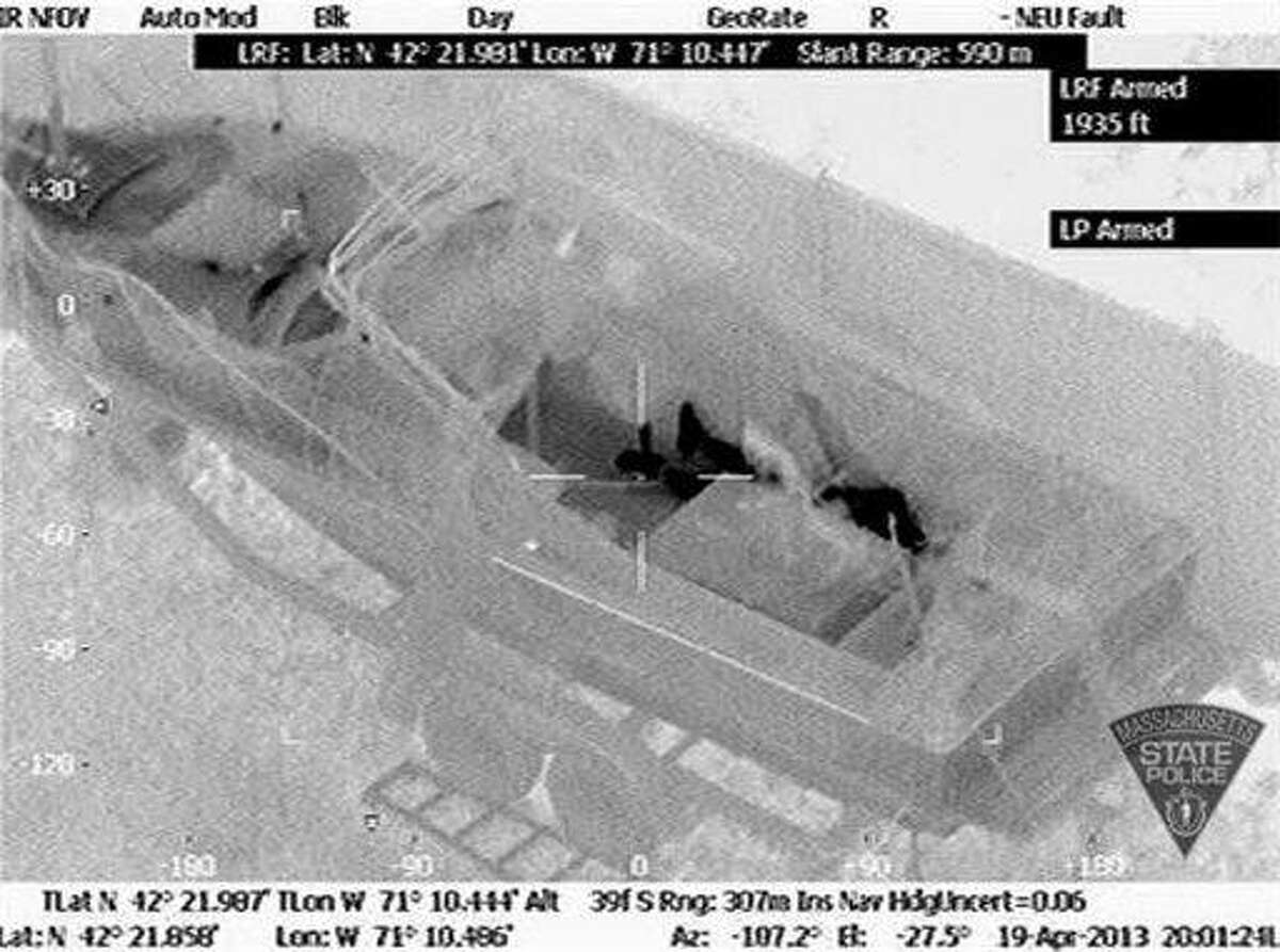 This Friday, April 19, 2013 image made available by the Massachusetts State Police shows 19-year-old Boston Marathon bombing suspect, Dzhokhar Tsarnaev, hiding inside a boat during a search for him in Watertown, Mass. He was pulled, wounded and bloody, from the boat parked in the backyard of a home in the Greater Boston area. (AP Photo/Massachusetts State Police)