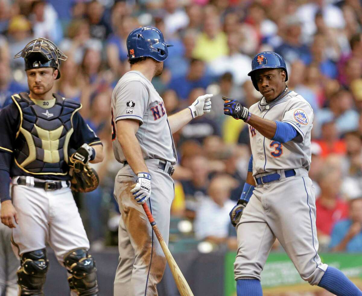 New York Mets Curtis Granderson, right, and Daniel Murphy celebrate Granderson’s home run on Saturday in Milwaukee.