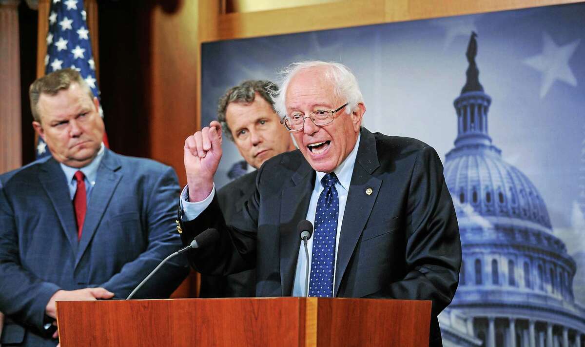 Sen. Bernie Sanders, I-Vt., right, joined by Sen. Jon Tester, D-Mont., left, and Sen. Sherrod Brown, D-Ohio, center, speaks during a news conference on Capitol Hill in Washington on July 24, 2014, about the Veterans Administration.