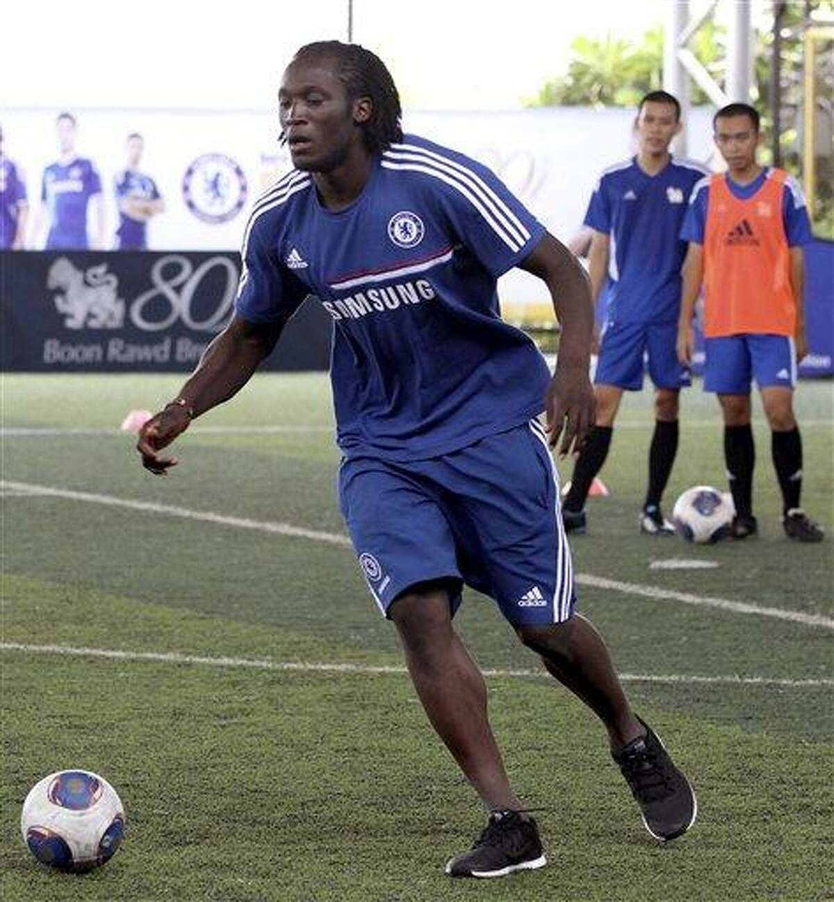 Romelu Lukaku of Chelsea shows his soccer skill to Thai youth during a soccer coaching clinic for Thai students in Bangkok, Thailand Monday, July 15, 2013. Chelsea will play against Thailand Singha All Star on Wednesday, July 17, 2013. (AP Photo/Apichart Weerawong)