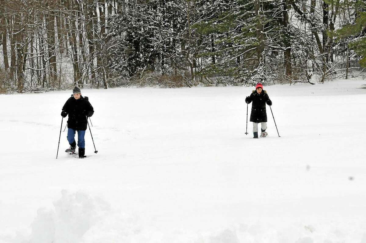 Laura and Jimmy Pavlick of Litchfield on snow shoes at White Memorial in Litchfield.