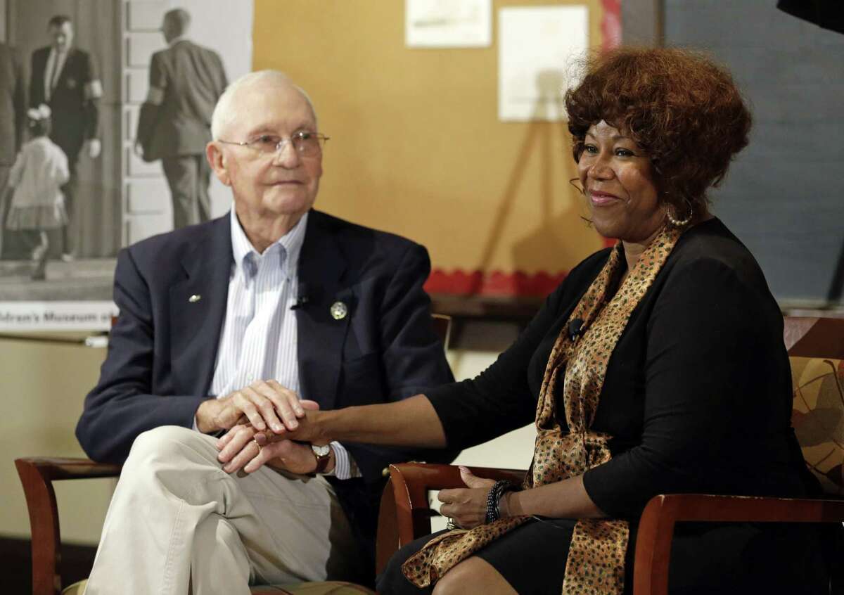 FILE - In this Thursday, Sept. 5, 2013, file photo, Ruby Bridges, right, who integrated Louisiana schools in 1960 under escort from U.S. Marshals, meets with Charles Burks, who was one of those marshals, at the Indianapolis Children's Museum in Indianapolis. On Friday, Nov. 14, 2014, 54 years later to the day when she first walked up the steps to William Frantz Elementary School, Bridges is scheduled to commemorate the event with the unveiling of a statue in her likeness on the campus. (AP Photo/Michael Conroy, File)