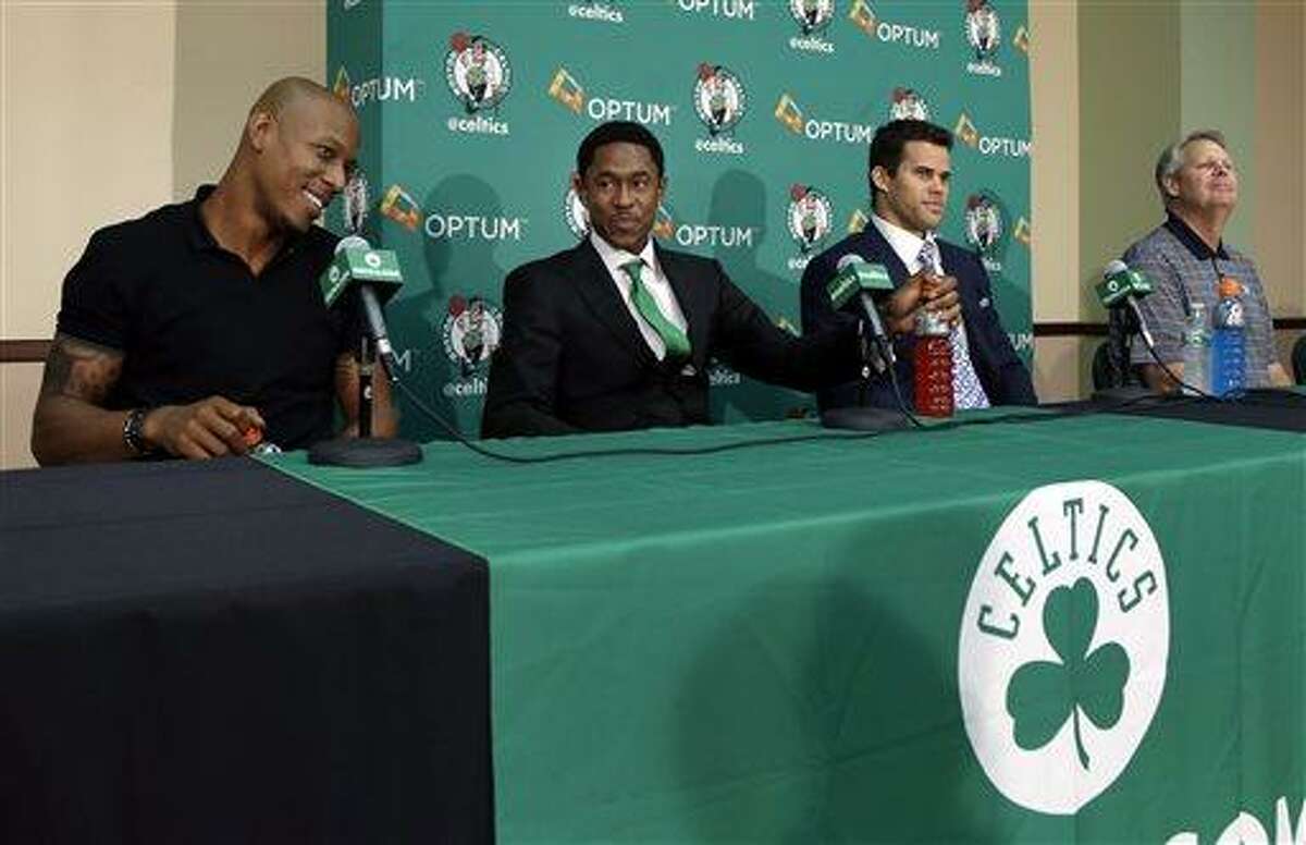 Newly acquired Boston Celtics players, from left, Keith Bogans, MarShon Brooks and Kris Humphries listen to a question along with Celtics president of basketball operations Danny Ainge, far right, in Waltham, Mass., Monday, July 15, 2013, during an NBA basketball news conference to introduce players they acquired from the Brooklyn Nets in exchange for Kevin Garnett and Paul Pierce. (AP Photo/Elise Amendola)