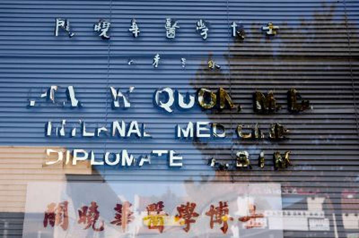 Dr. Hew Wah Quon's name is half-peeled off the front window of his office in the Chinatown neighborhood of Los Angeles, Calif.