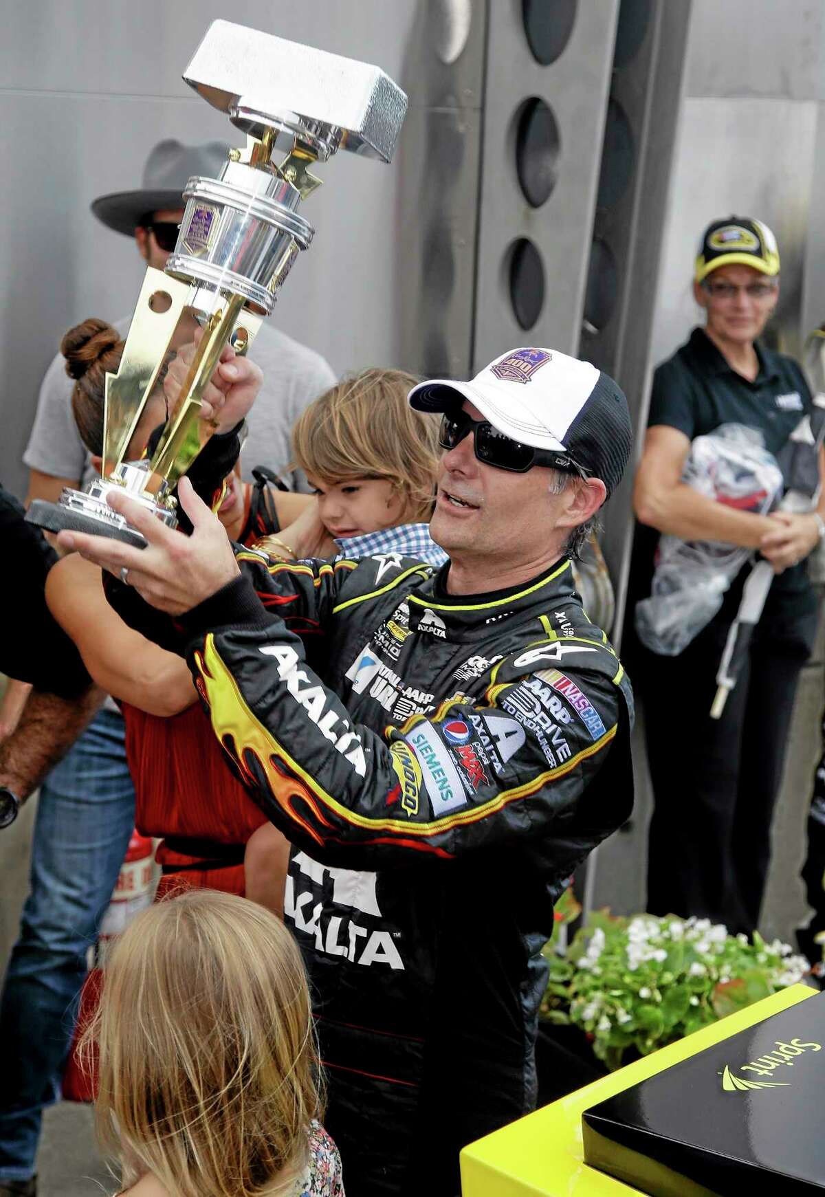 Jeff Gordon holds up the trophy after winning the Brickyard 400 Sunday.