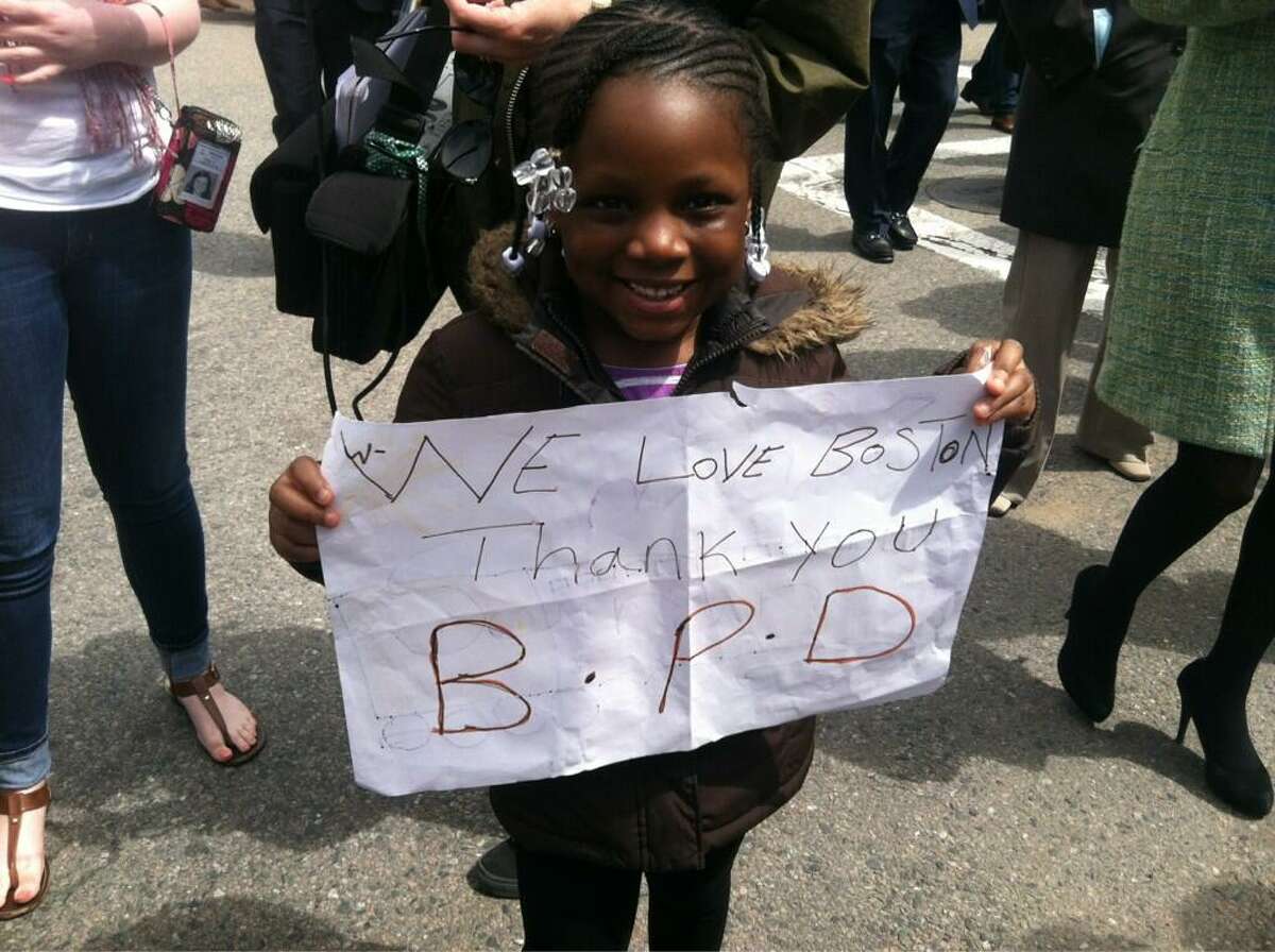 Saran Fofana, 5, thanks the Boston Police Department. Jennifer Swift/Register