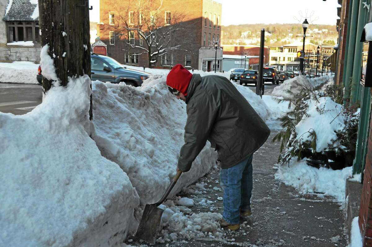 Jason Truby cleared the sidewalk in front of the former Morrison W H Co. building in Torrington.