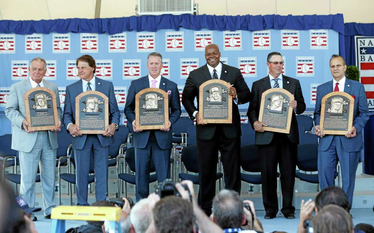 National Baseball Hall of Fame inductees, from left, Bobby Cox, Tony La Russa, Tom Glavine, Frank Thomas, Greg Maddux and Joe Torre hold their plaques after Sunday’s induction ceremony in Cooperstown, N.Y.