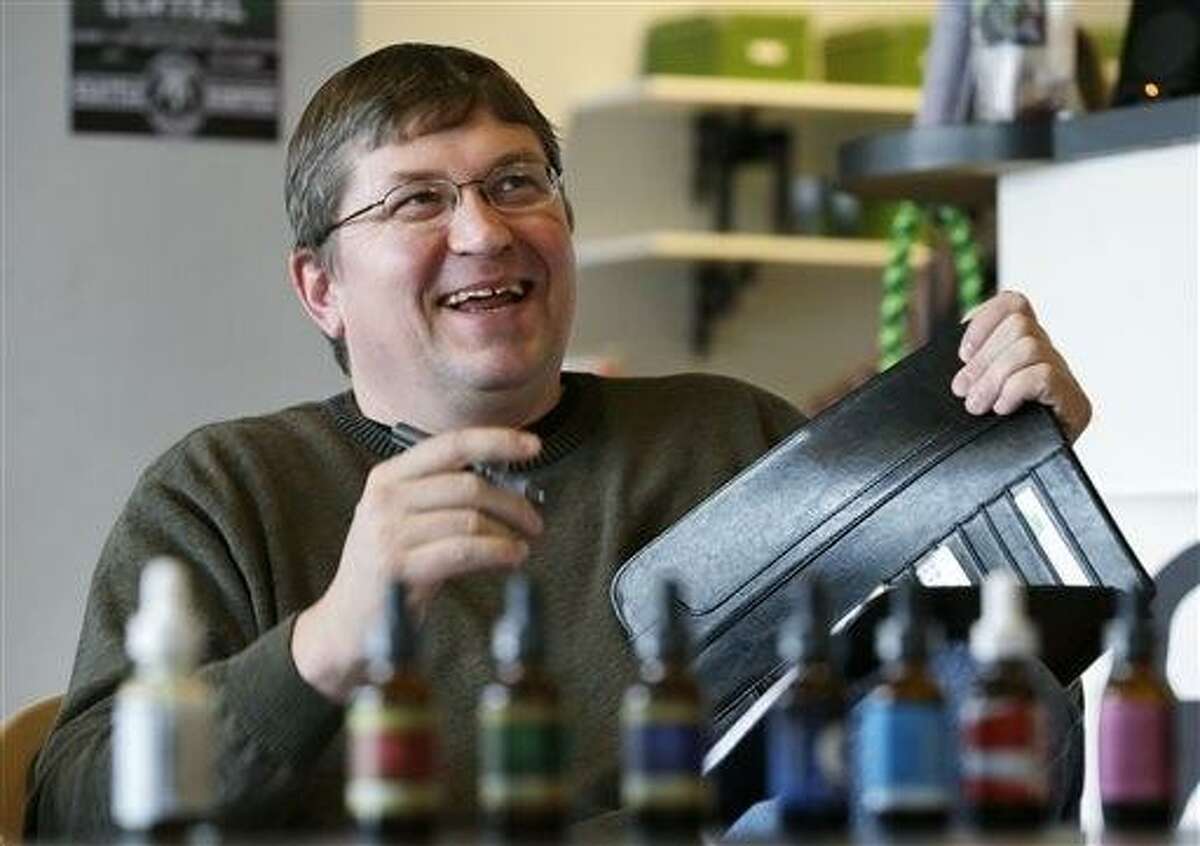 Mike Steenhout, comptroller of Washington's Liquor Control Board, smiles during a presentation about marijuana plant extracts at a medical marijuana clinic in Seattle. AP Photo/Elaine Thompson