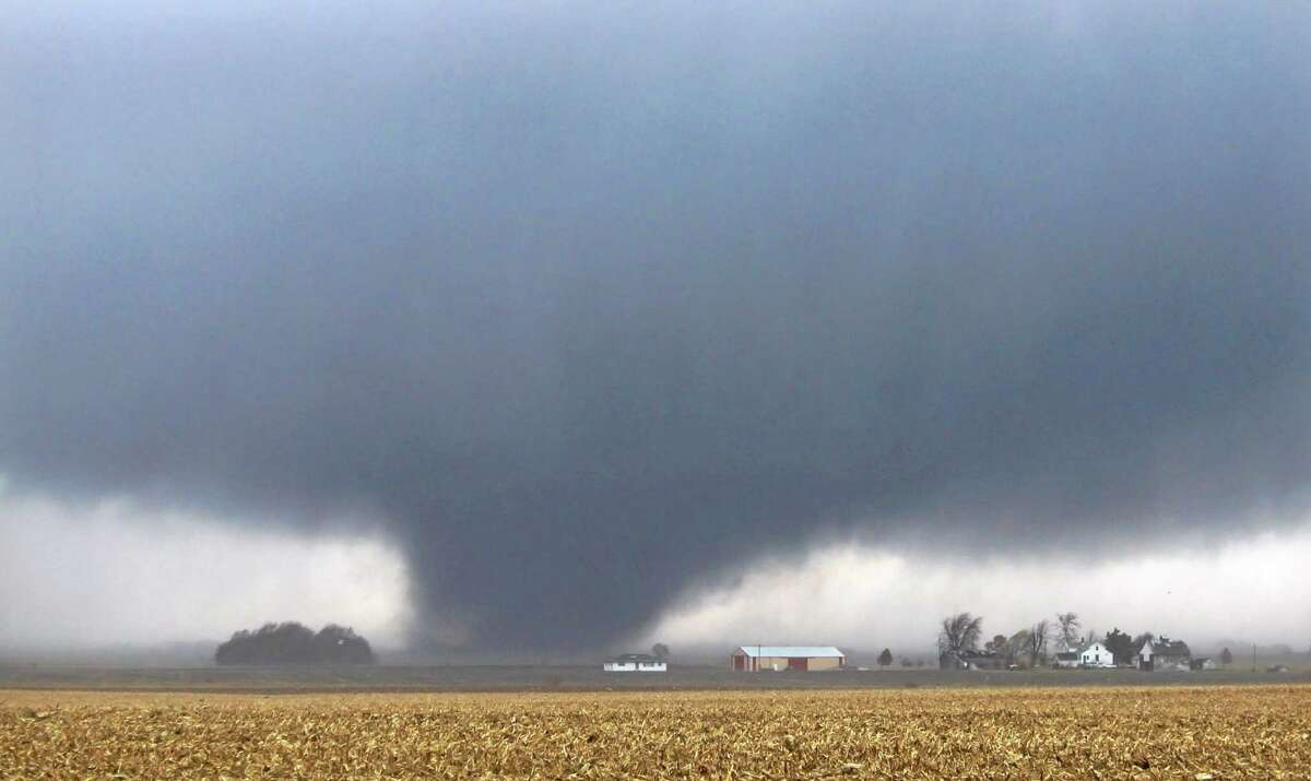 A tornado moves northeast Sunday, Nov. 17, 2013, two miles west of Flatville, Ill. The tornado damaged many farm buildings and homes on its way to Gifford, Ill., where scores of houses were devastated. (AP Photo/News-Gazette, Jessie Starkey) MANDATORY CREDIT