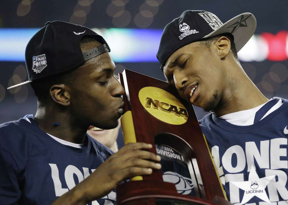 UConn guards Terrence Samuel, left, and Ryan Boatright hold the national championship trophy after beating Kentucky 60-54 on April 7 in Arlington, Texas.