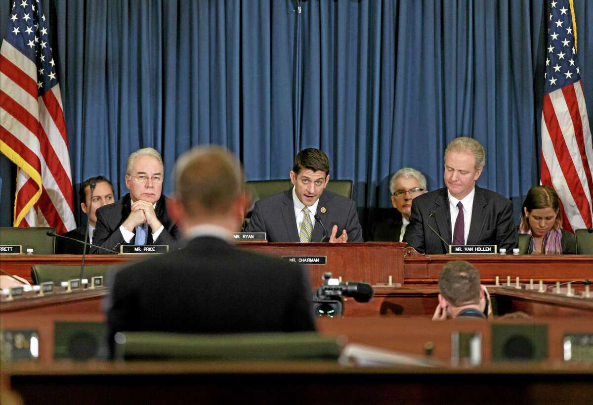 House Budget Committee Chairman Rep. Paul Ryan, R-Wis., center, flanked by the committee's ranking member Rep. Chris Van Hollen, D-Md., right, and Rep. Tom Price, R-Ga., left, poses questions to Congressional Budget Office (CBO) Director Douglas Elmendorf during the committee's hearing on Capitol Hill in Washington, Wednesday, Feb. 5, 2014. Adding fresh fuel to the political fight over "Obamacare,î Republican lawmakers have seized on a Congressional Budget Office report that predicts nationwide job losses because of the health care program. (AP Photo/J. Scott Applewhite)