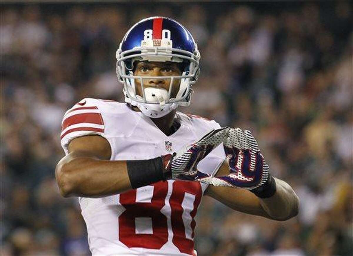 FILE - In this Sept. 30, 2012 file photo, New York Giants wide receiver Victor Cruz (80) celebrates his touchdown against the Philadelphia Eagles during an NFL football game in Philadelphia. (AP Photo/Mel Evans, File)