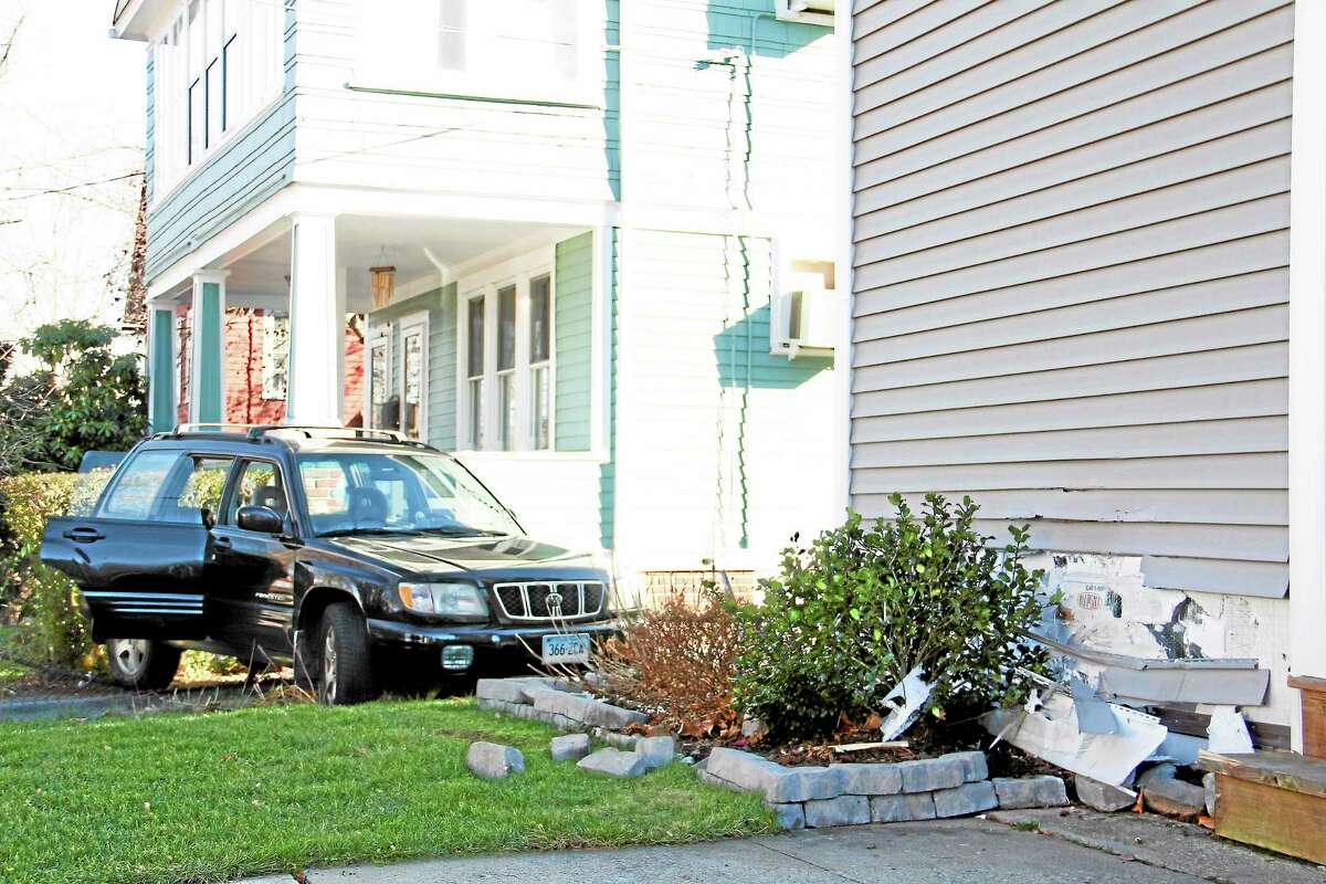 A man drove his car into a house across the street from his Travis Drive home on Monday, Nov. 18, 2013 in Torrington.