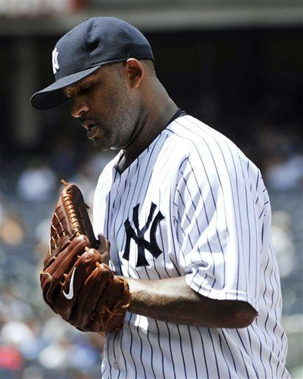 New York Yankees starting pitcher CC Sabathia walks off the field at the top of the third inning after giving up a three-run home run to Minnesota Twins' Aaron Hicks in a baseball game at Yankee Stadium on Sunday, July 14, 2013 in New York. The Twins won 10-4. (AP Photo/Kathy Kmonicek)