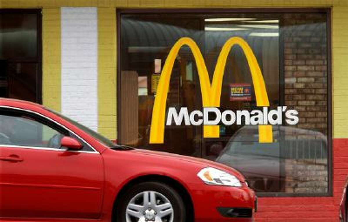 A car moves through a McDonald's drive through window line, in Springfield, Ill.