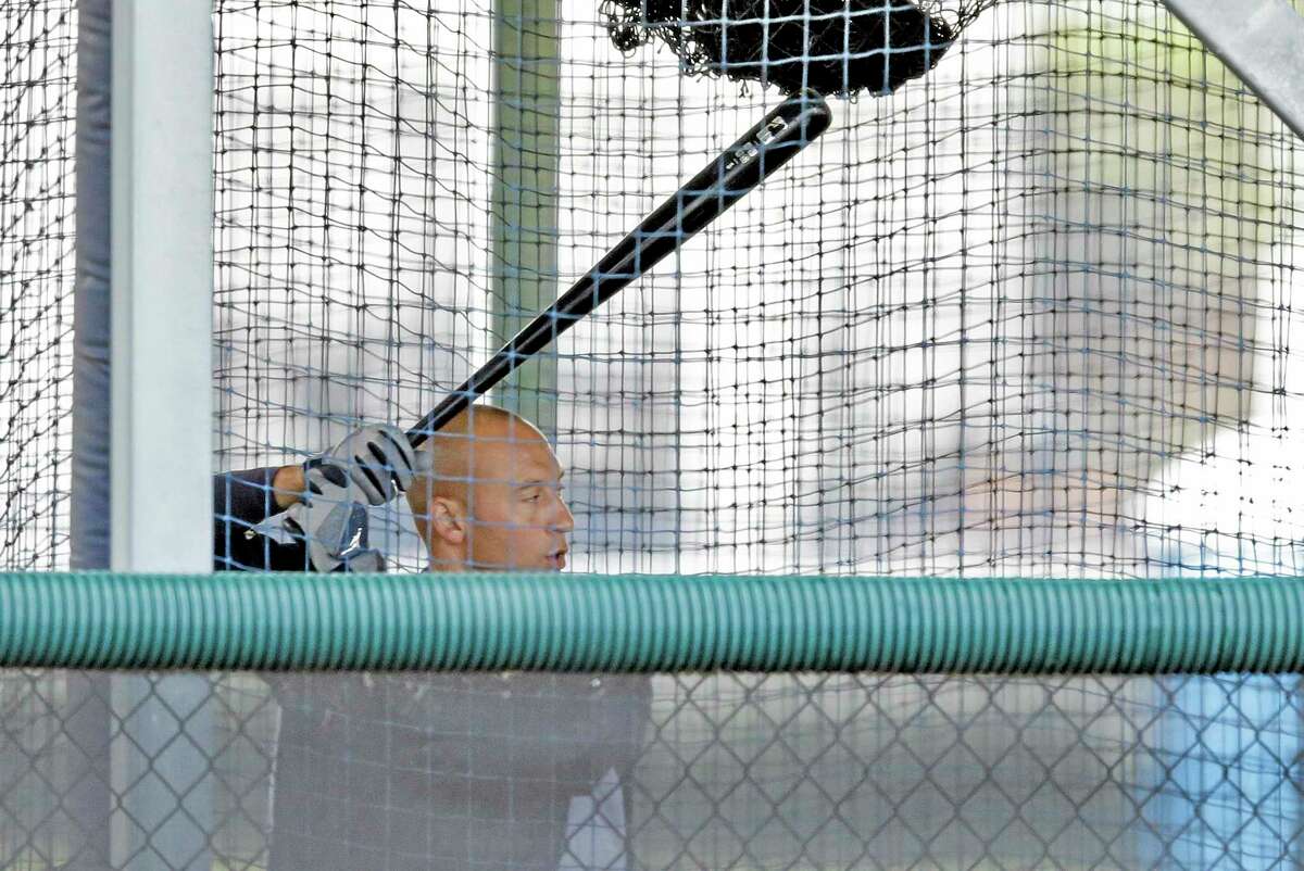 New York Yankees shortstop Derek Jeter hits in a batting cage during a workout at the team’s minor league facility on Thursday in Tampa, Fla.