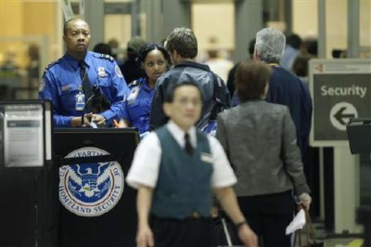 TSA officials check passengers entering a security checkpoint at Hartsfield-Jackson Atlanta International Airport in Atlanta.