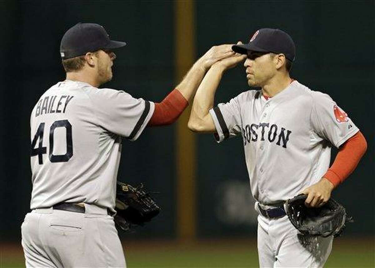 Boston Red Sox relief pitcher Andrew Bailey (40) celebrates with center fielder Jacoby Ellsbury after a 6-3 win over the Cleveland Indians in a baseball game on Thursday, April 18, 2013, in Cleveland. (AP Photo/Mark Duncan)