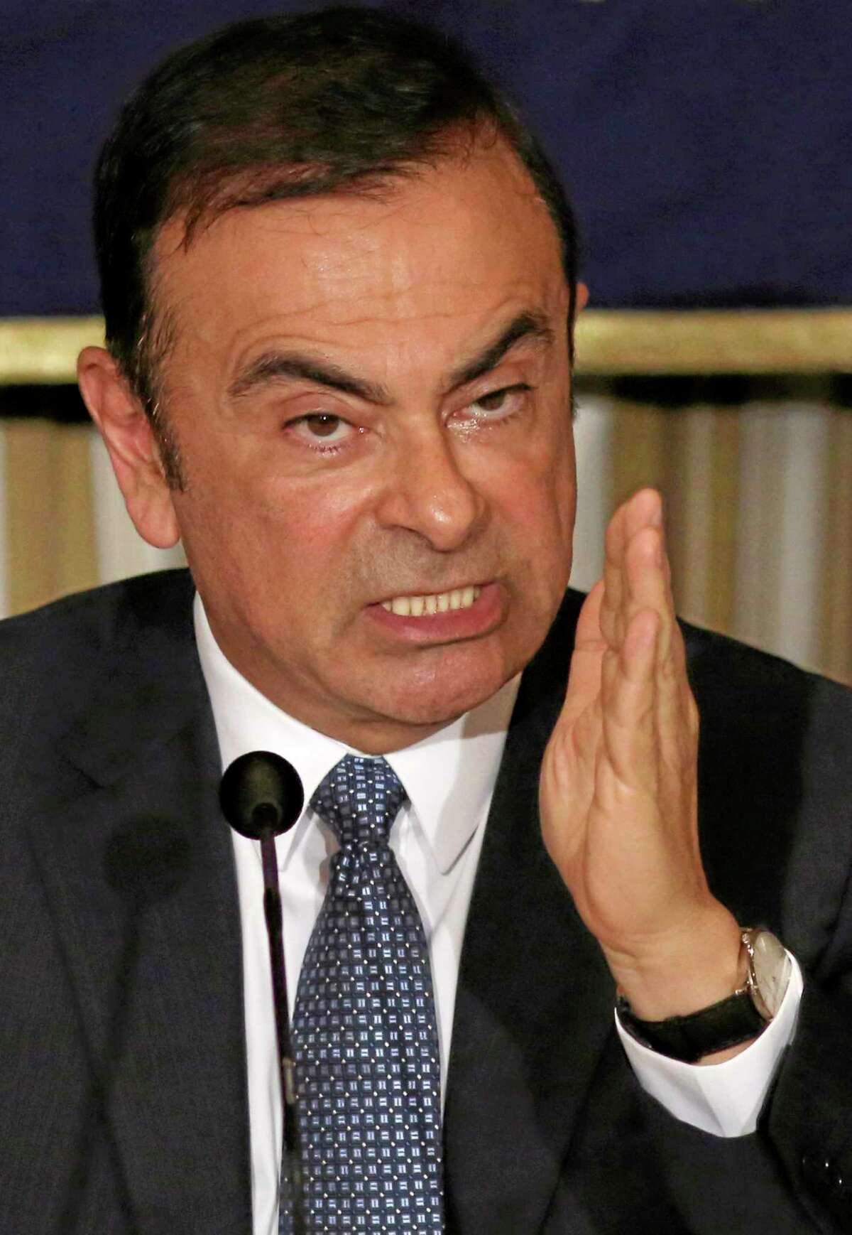Nissan Chief Executive Carlos Ghosn gestures while speaking during a press conference at Foreign Correspondents' Club of Japan in Tokyo, Thursday, July 17, 2014. Ghosn, who has long made a point of promoting women to management positions, said the Japanese Prime Minister Shinzo Abe's plan to boost female bosses to 30 percent by 2020 is too ambitious. The participation of women in Japan's workforce is very low by developed nation standards. Women make up 2.9 percent of manager-level and higher positions at Japanese companies employing 5,000 or more people. (AP Photo/Eugene Hoshiko)