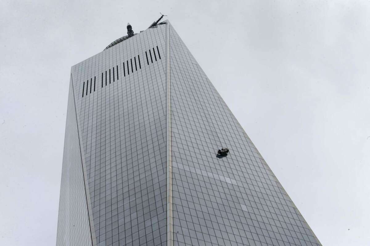 A partially collapsed scaffolding hangs from the 1 World Trade Center in New York, Wednesday, Nov. 12, 2014. New York City firefighters have been called to the nation’s tallest skyscraper, where two workers are stuck on scaffolding 69 stories above street level.