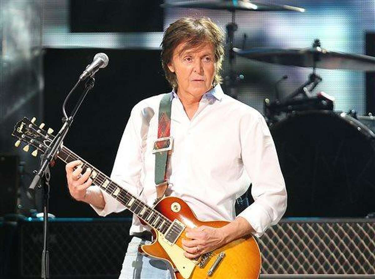 FILE - This Dec. 12, 2012 file image released by Starpix shows Paul McCartney at the 12-12-12 The Concert for Sandy Relief at Madison Square Garden in New York. McCartney is adding his voice to Tony Bennett's campaign against gun violence. The former Beatle recorded a voice message that's part of a text-to-call operation Wednesday, April 17, 2013, for Bennett's Voices Against Violence campaign. McCartney and others are encouraging Americans to send a text, which will lead to the singer's message and connect the caller to their local senate office after proving their zip code. (AP Photo/Starpix, Dave Allocca, file)