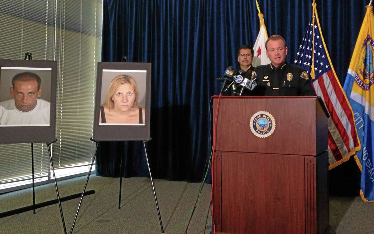 Long Beach Police Chief Jim McDonnell leads a news conference Thursday, July 24, 2014, in Long Beach, Calif. Police said they're deciding whether to arrest an 80-year-old man who shot a fleeing, unarmed burglar despite her telling him she was pregnant, but they have arrested the woman's accomplice on suspicion of murder for taking part in a crime that led to her death. Photos at left show the surviving suspect, Gus Adams, and the Andrea Miller, who was killed. (AP Photo/The Press-Telegram, Gregory Yee)