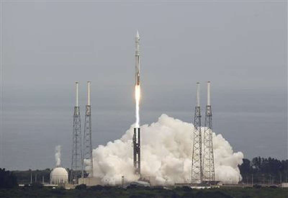 NASA's Maven, short for Mars Atmosphere and Volatile Evolution, with a capital "N'' in EvolutioN, atop a United Launch Alliance Atlas 5 rocket, lifts off from Cape Canaveral Air Force Station, Monday, Nov. 18, 2013, in Cape Canaveral, Fla. The spacecraft will orbit Mars and study the planet's upper atmosphere. (AP Photo/John Raoux)