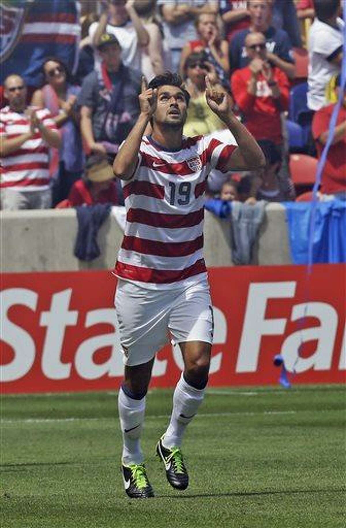 United States' Chris Wondolowski (19) celebrates after scoring against Cuba during the second half of a CONCACAF Gold Cup soccer game on Saturday, July 13, 2013, in Sandy, Utah. United States defeated Cuba 4-1. (AP Photo/Rick Bowmer)