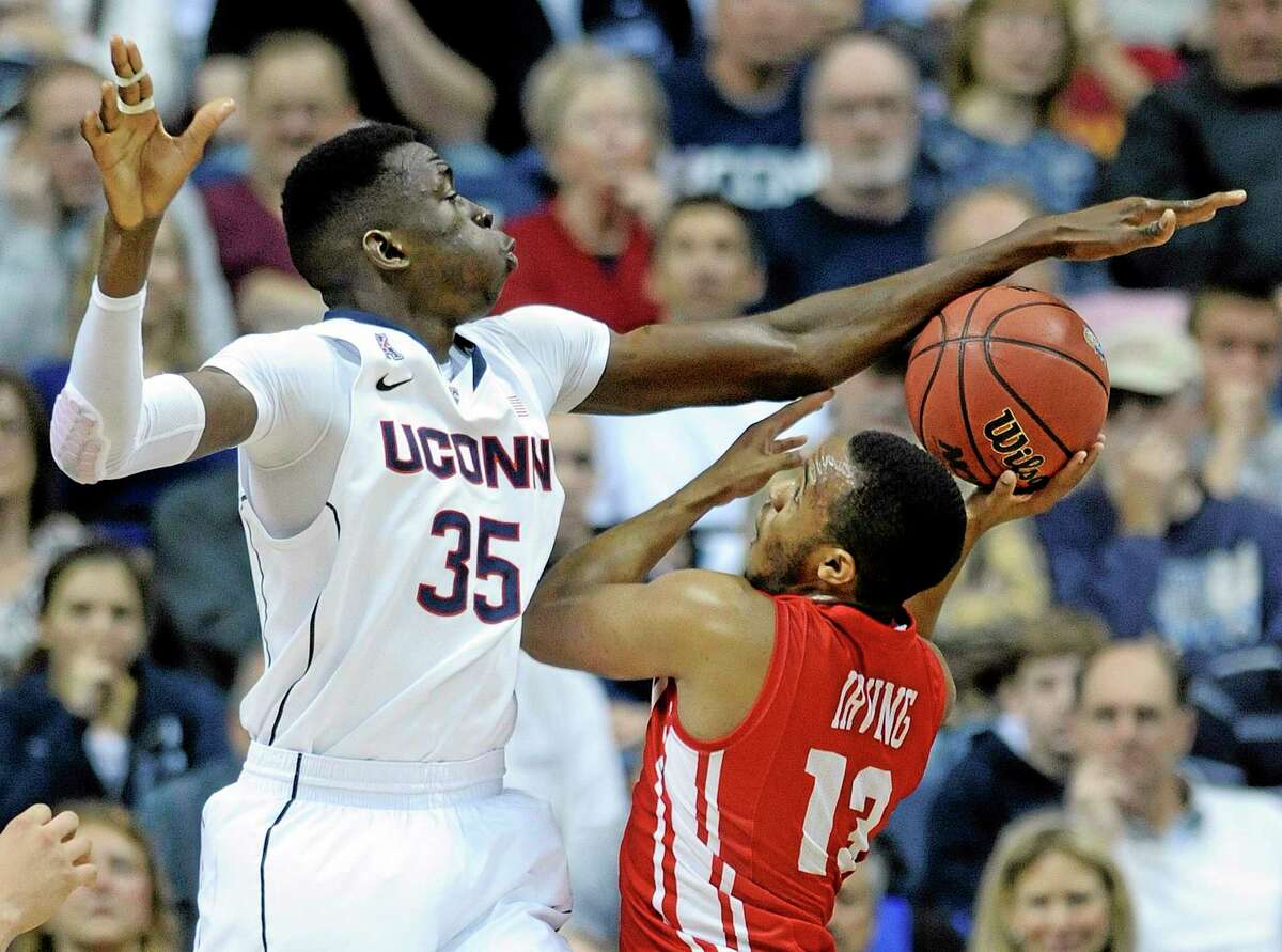 UConn’s Amida Brimah attempts to block the shot of Boston University’s D.J. Irving during Saturday’s game in Storrs.