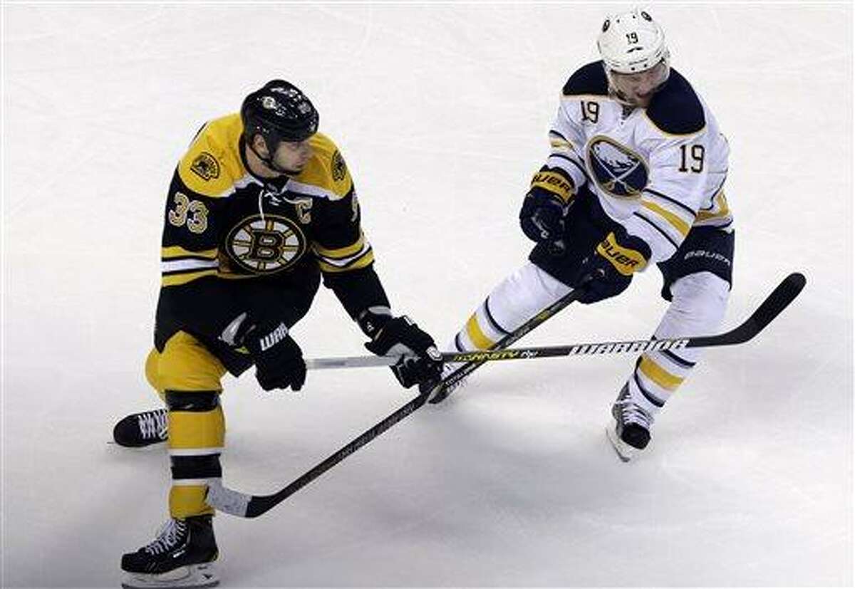 Boston Bruins defenseman Zdeno Chara (33) battles for position with Buffalo Sabres center Cody Hodgson (19) during the first period of an NHL hockey game in Boston, Wednesday, April 17, 2013. (AP Photo/Elise Amendola)