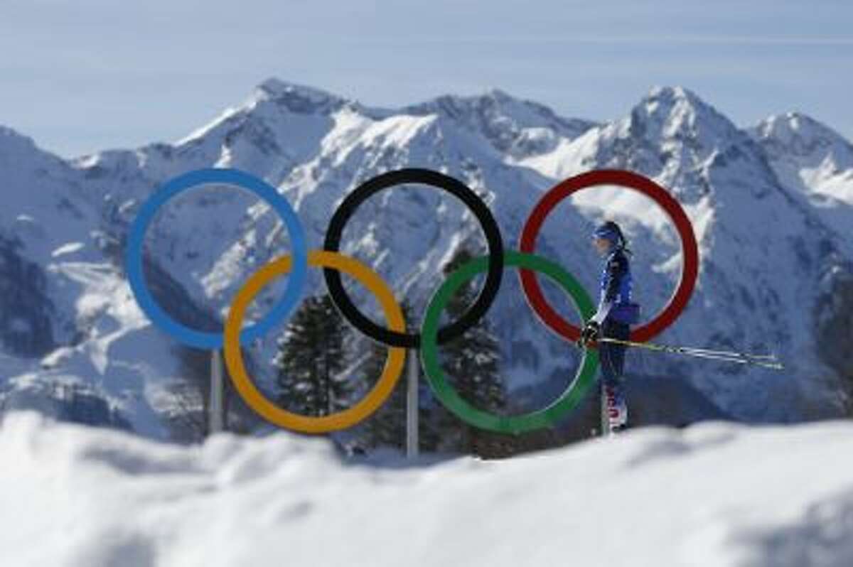 Annelies Cook of the United States passes by the Olympic rings during a biathlon training session prior to the 2014 Winter Olympics, Friday, Feb. 7, 2014, in Krasnaya Polyana, Russia.