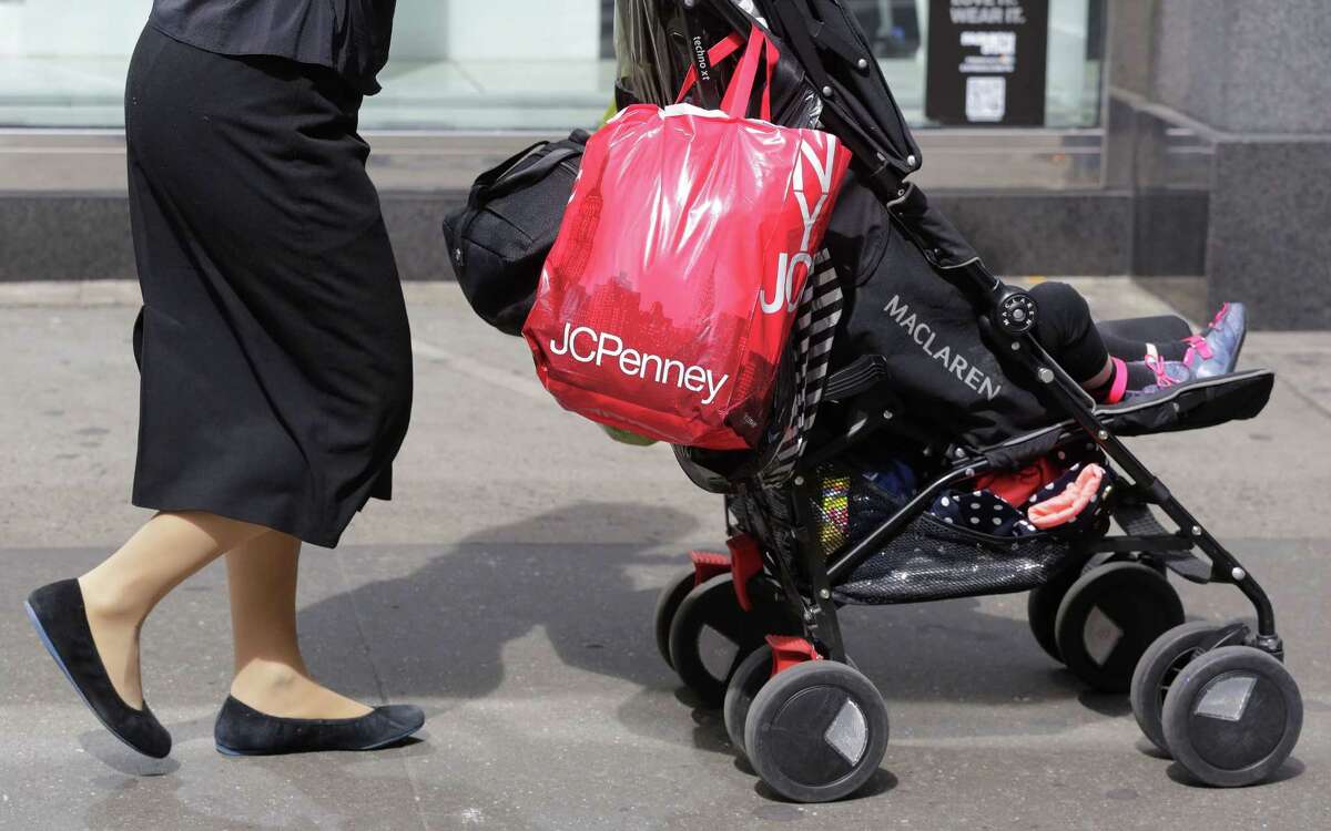 In this April 9, 2013, photo, a shopper carries a J.C. Penney bag in New York.