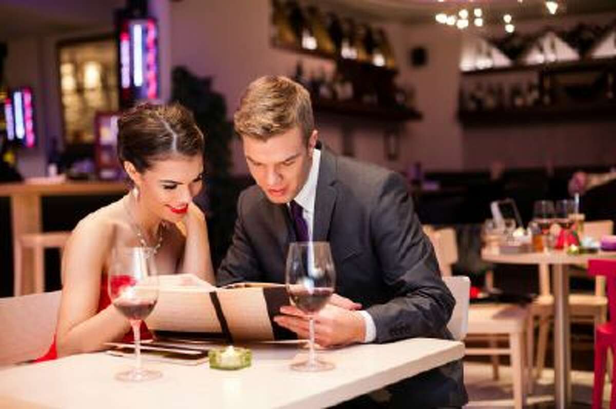 A couple looks at a restaurant menu.
