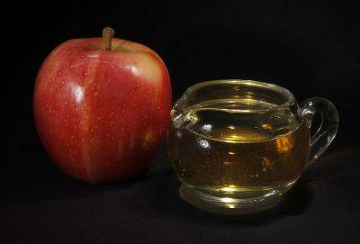 In this Sept. 15, 2011 photo, an apple and a pitcher of apple juice are posed together in Moreland Hills, Ohio. The Food and Drug Administration is setting a new limit on the level of arsenic allowed in apple juice, after more than a year of public pressure from consumer groups worried about the contaminant's effects on children. (AP Photo/Amy Sancetta, File)