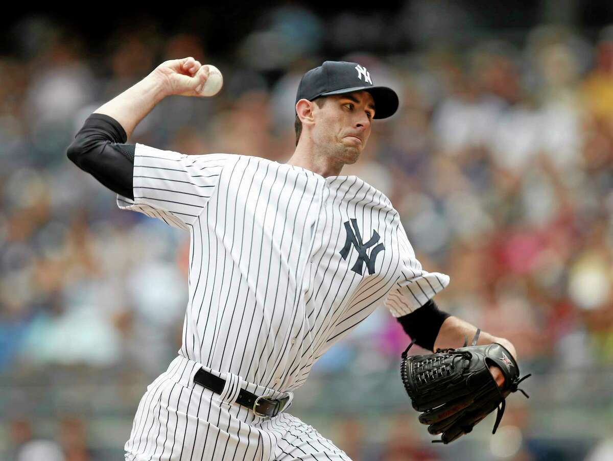 The Associated Press Yankees starting pitcher Brandon McCarthy delivers in the first inning of Thursday’s game against the Texas Rangers at Yankee Stadium in New York.
