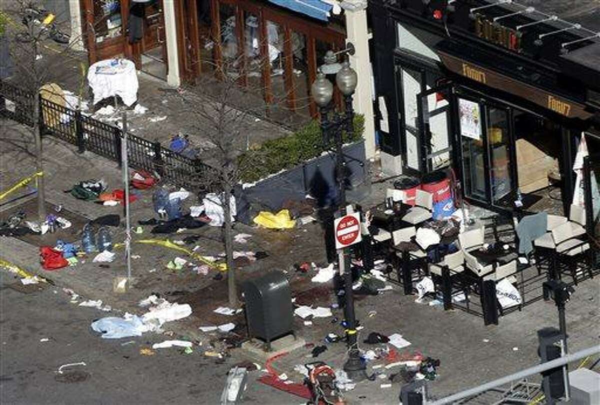 One of the blast sites on Boylston Street near the finish line of the 2013 Boston Marathon is seen in Boston, Tuesday, April 16, 2013, one day after bomb blasts killed three and injured over 140 people. FBI agents searched a suburban Boston apartment overnight and appealed to the public for amateur video and photos that might yield clues to who carried out the Boston Marathon bombing. (AP Photo/Elise Amendola)