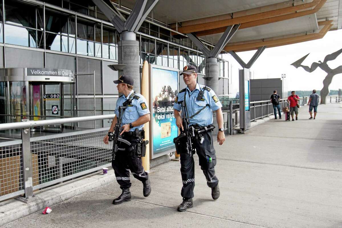 Armed Police patrol outside the terminal building Thursday at Oslo Airport. Norway’s intelligence service says it has been warned of an imminent “concrete threat” against the nation from people with links to Islamic fighters in Syria.