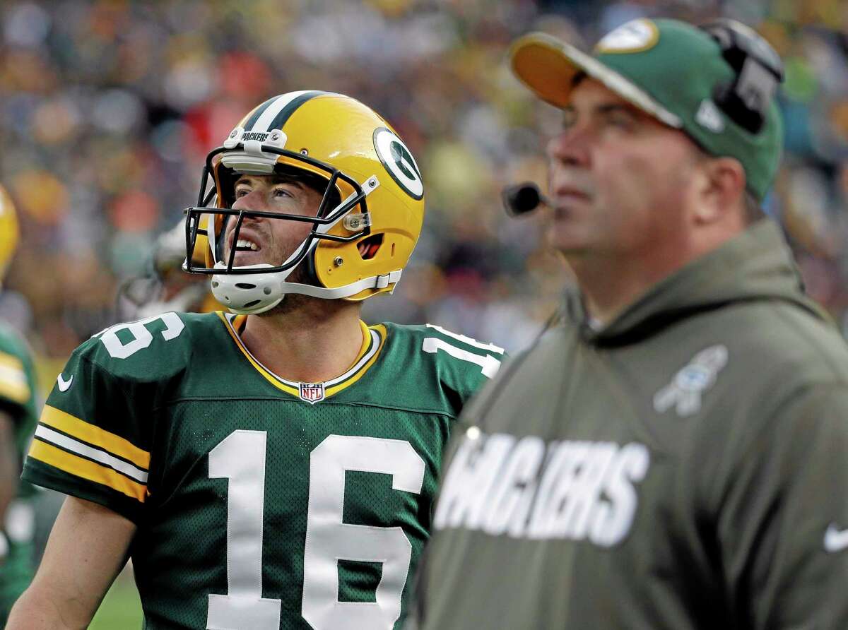 Packers head coach Mike McCarthy and quarterback Scott Tolzien look at a video board during their game against the Eagles last Sunday.